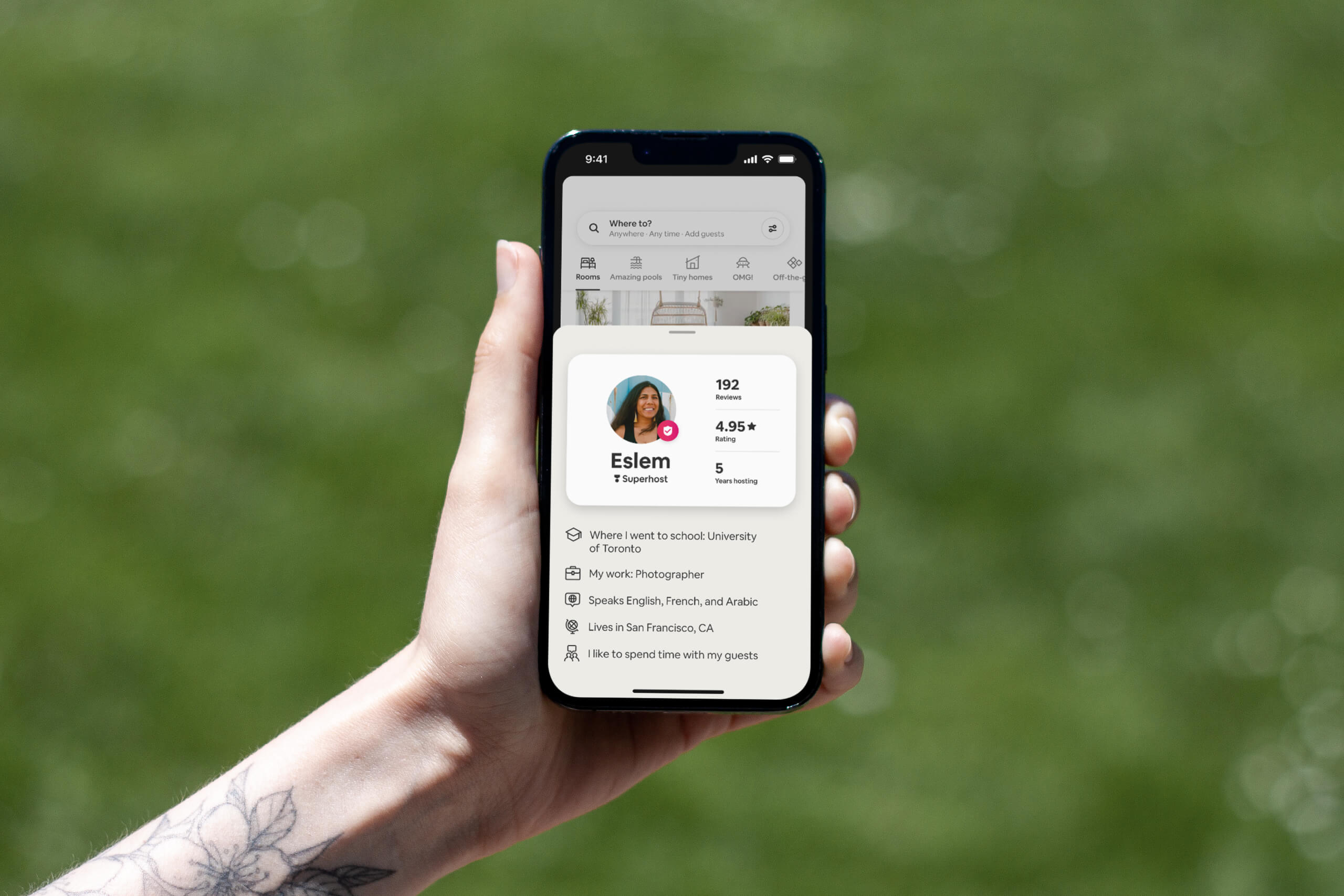 iPhone 13 Pro being held showing an Airbnb Host Passport of a host named Eslem