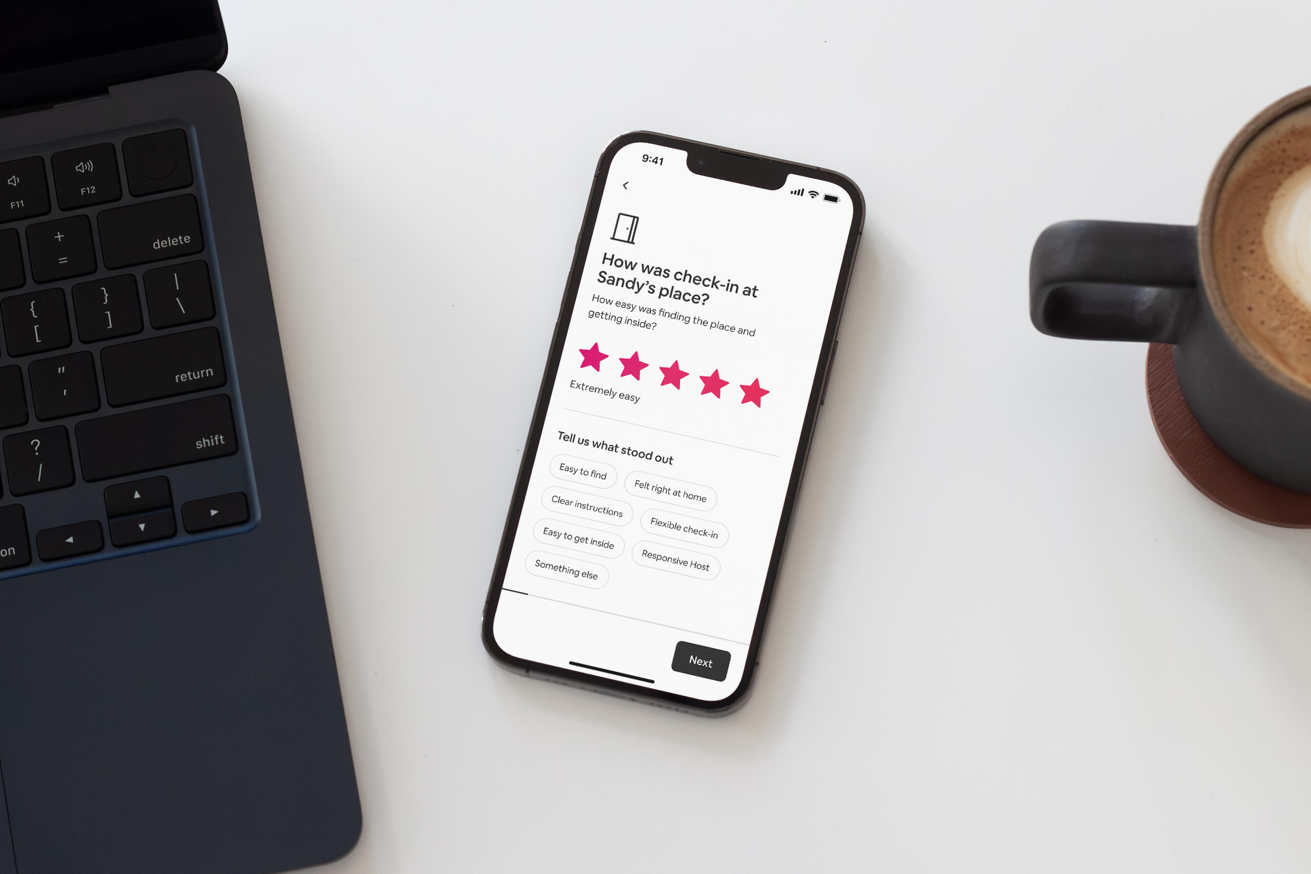 iPhone 13 Pro sitting on a desk show the Airbnb review flow